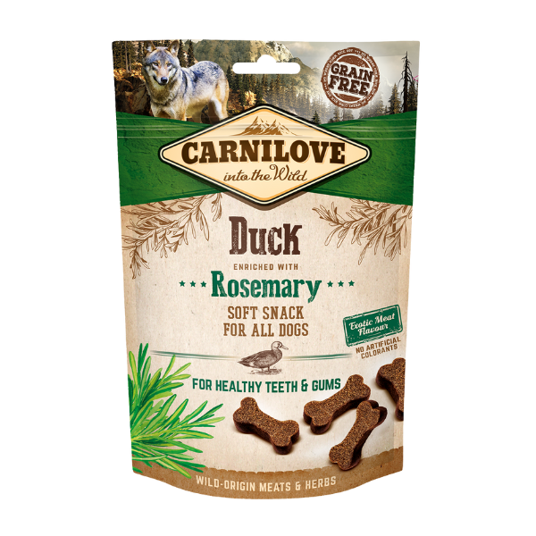 Duck & rosemary Carnilove snack bag with bone-shaped treats; text: healthy teeth, wild meats, grain-free.
